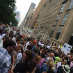 New York street fill with people holding  signs including "Climate Change is a Health Crisis"