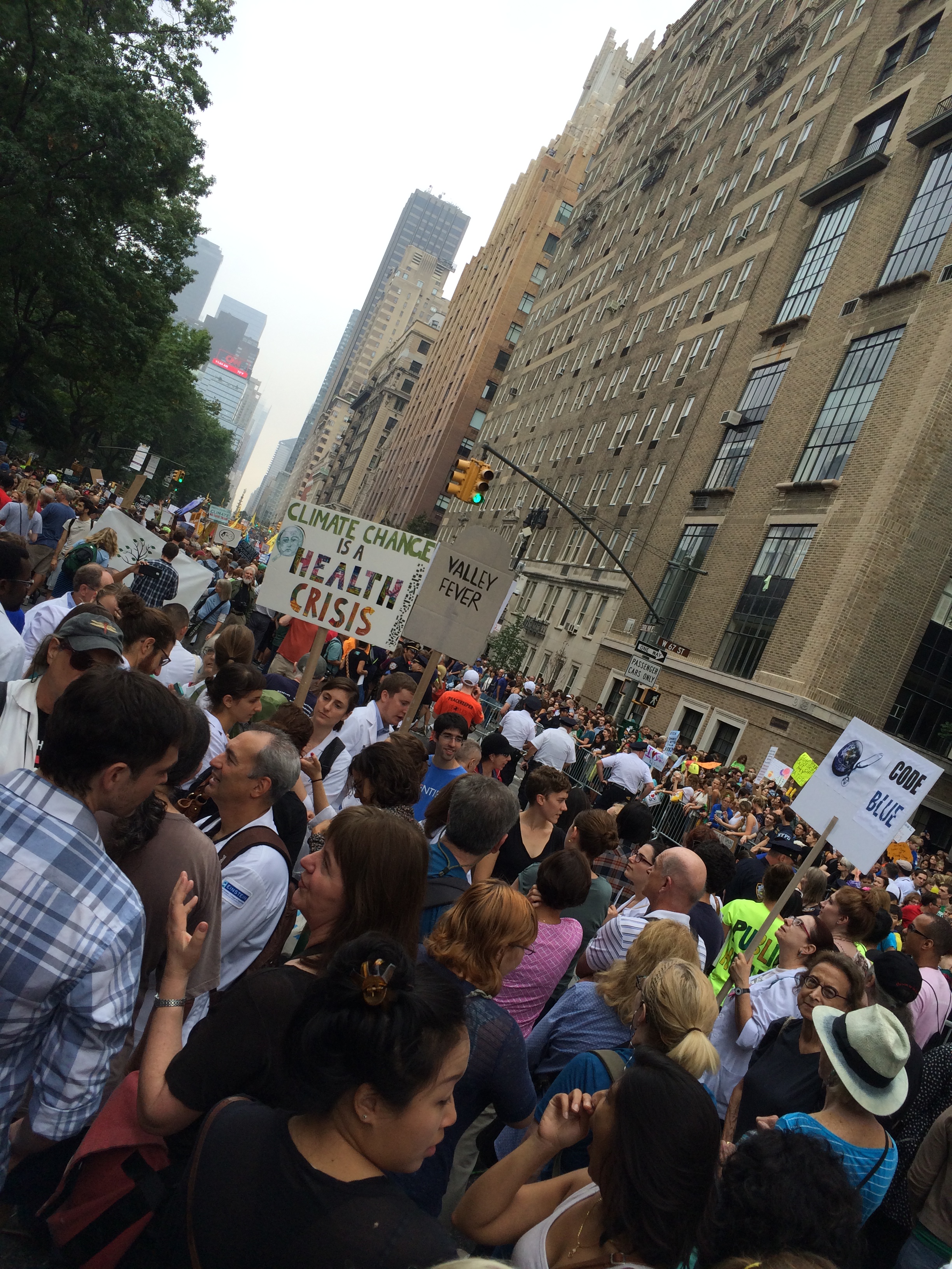 New York street fill with people holding signs including "Climate Change is a Health Crisis"